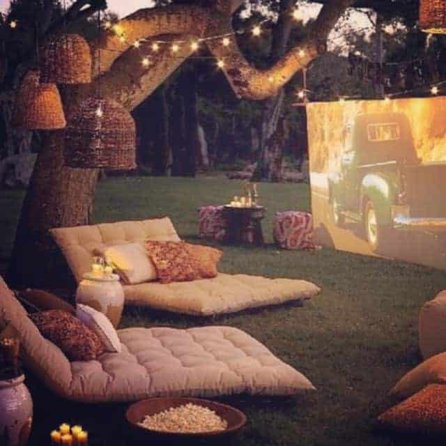 Another Pinterest image. Carefully curated outdoor movie setting. Notice the lovely warm lights that make things a lot more inviting and intimate than an unlit setting. Image from infohomeideas.com.